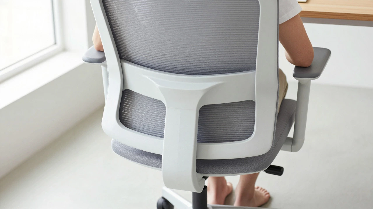 Person sitting upright in ergonomic chair with proper spinal alignment and lumbar support
